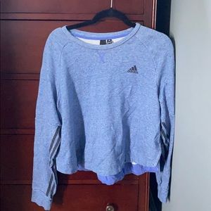 blue and black long sleeved cropped adidas shirt.